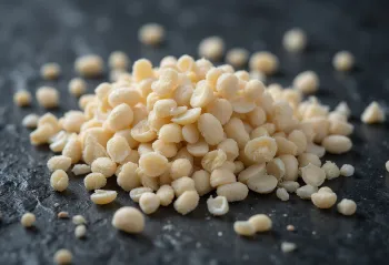White poppy seeds close up, piled on a light surface