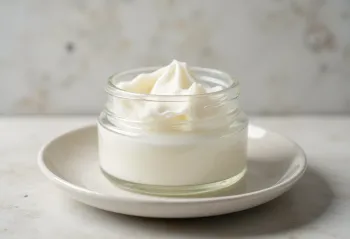 Refined coconut oil in a small bowl, next to white coconut flakes