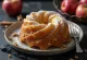 Cinnamon Apple Bundt Cake sliced and dusted with powdered sugar
