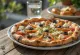 Pizza Greca with feta cheese, black olives, and fresh tomato