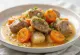 Rabbit stew with white wine and herbs served in a rustic bowl