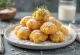 Crispy milk fritters served with a dusting of milk powder
