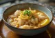 Bowl of Chicken Arroz Caldo topped with garlic and egg