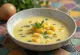 Creamy yellow lemon chicken soup garnished with fresh dill