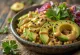 Avocado quinoa bowl drizzled with curry tahini sauce