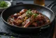 Saucy Galbi served with sesame seeds and cilantro