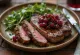 Grilled ostrich meat served with fresh salad