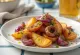 BBQ grilled potato wedges with red onion on a tray
