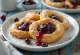 Zeppole filled with sour cherry jam and dusted with sugar