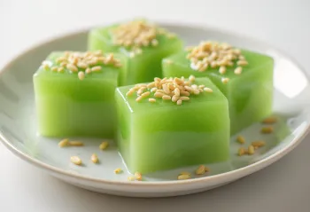 Green matcha kuzumochi with silky texture served with sesame seeds