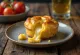 Cheesy Yorkshire puddings, golden brown batter filled with melted cheese
