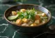 Tofu Pho served in a bowl with rice noodles, fresh cilantro and lime slices