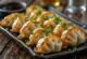 Garlic Gyoza served with meaty filling, crispy bottom and golden brown color.