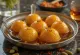 Saffron Gulab Jamun, sweet golden-brown balls in syrup