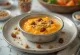 Carrot payasam garnished with fresh pistachios and raisins