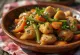 Adobo with vegetable ragout, garnished with fresh cilantro