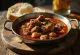 Hearty wild boar stew with rich gravy, served with potatoes.
