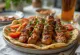 Grilled Urfa kebab skewers served with flatbread and vegetables