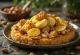 Maqluba with chicken – layered rice, fried vegetables and chicken inverted