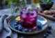 Glass of blueberry ginger kombucha with ice and fresh berries