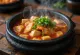 Kimchi Jjigae, bubbling spicy Korean stew with tofu and pork