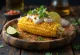Elote with Sour Cream - fresh corn served with sour cream, cheese, and spicy paprika