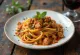 Seitan pasta garnished with fresh basil